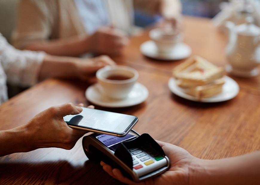 image of person using phone to pay restaurant bill